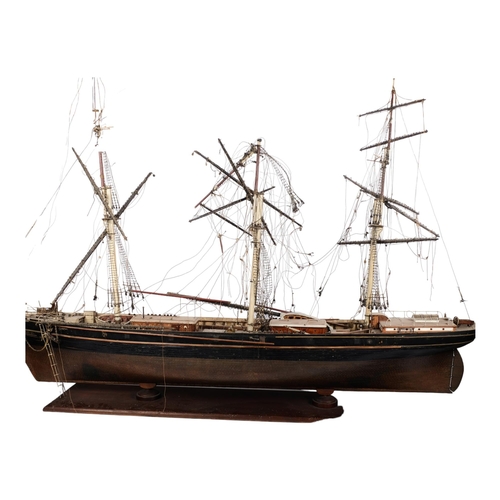 125 - A scratch-built riveted model of the Cutty Sark, with a box of associated accessories and spare part... 