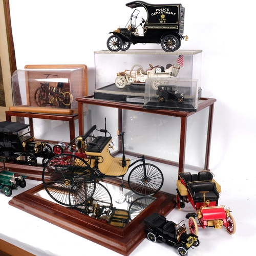 94 - A group of various diecast vehicles, some in associated display cases, including a Mercedes Benz pat... 