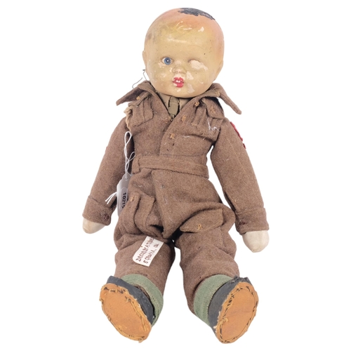 151 - An Antique doll, dressed in hand-made World War II military uniform, by 