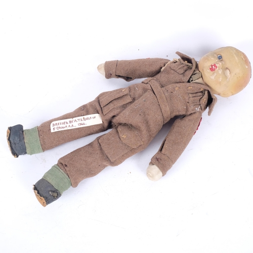 151 - An Antique doll, dressed in hand-made World War II military uniform, by 