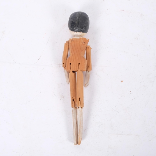 152 - A carved and painted wood-jointed peg doll, L29cm