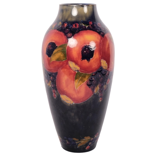 157 - MOORCROFT - a large Pomegranate decorated baluster vase, with incised mark and green signature to th... 