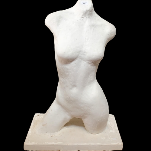 162 - A white painted plaster half sculptural female torso, on rectangular plinth base, W59cm, H88cm