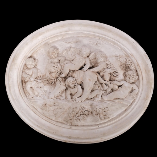 171 - An oval plaster plaque depicting cherubs leading a lion, W57cm