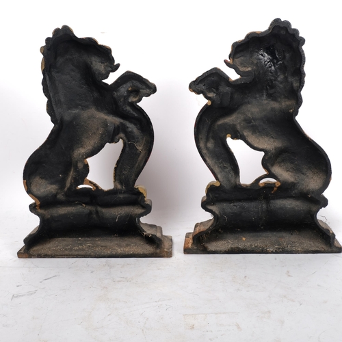 177 - A pair of gilded cast-iron heraldic rampant lion door stops, H36cm