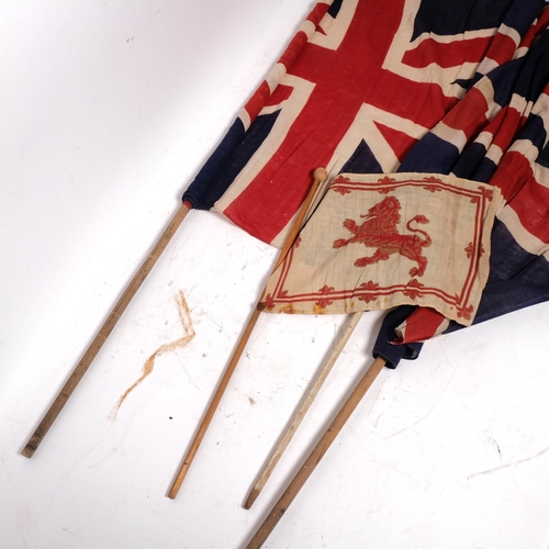 211 - A group of 3 Union Jacks, mounted on hand-held rods, 80 x 58cm approx, and a small British Standard ... 