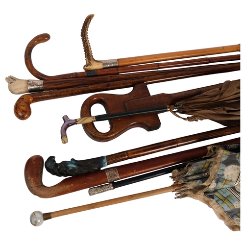 253 - A group of canes, walking sticks and parasols, including a silver collared