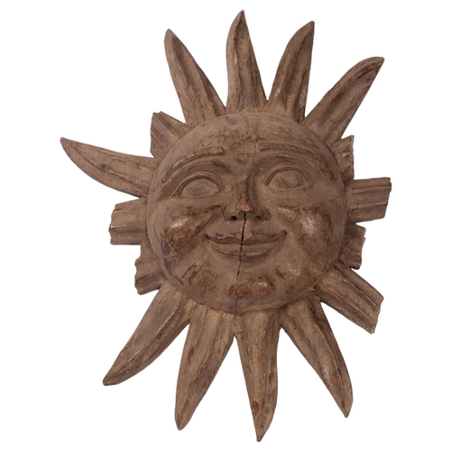 255 - A Gothic carved oak sun/moon wall sconce, diameter 50cm