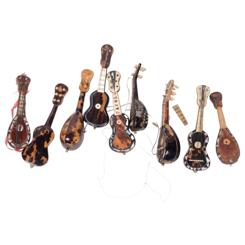 265 - A collection of miniature Italian tortoiseshell and mother-of-pearl mandolins and guitar (9)