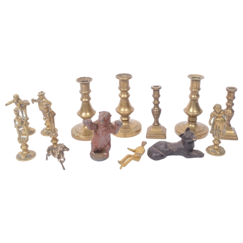 277 - A group of miniature brass candlesticks, painted lead bear etc