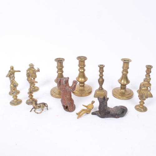 277 - A group of miniature brass candlesticks, painted lead bear etc