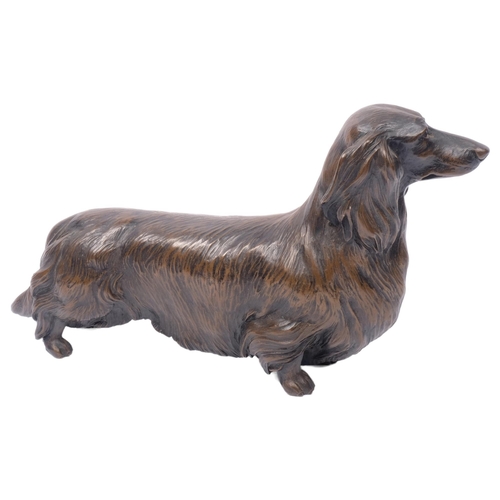 279 - M TURNER SCOTLAND, CIRCA 1985 - a patinated bronze study of a Dachshund, L25cm