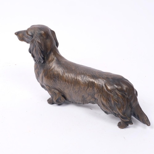 279 - M TURNER SCOTLAND, CIRCA 1985 - a patinated bronze study of a Dachshund, L25cm