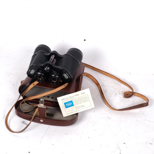 446 - A pair of Carl Zeiss Jenna 10x50 binoculars, marked DDR to the left of the eyepiece, with original c... 