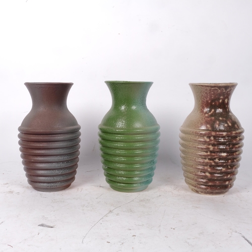 483 - A set of 3 Studio vases, an installation, the glaze colour changing from vase to vase, H24cm