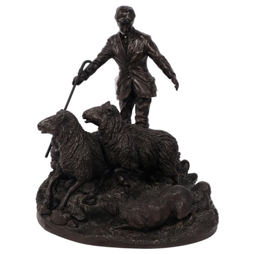 485 - A bronze effect composition sculpture of a shepherd, dog and sheep, H26cm