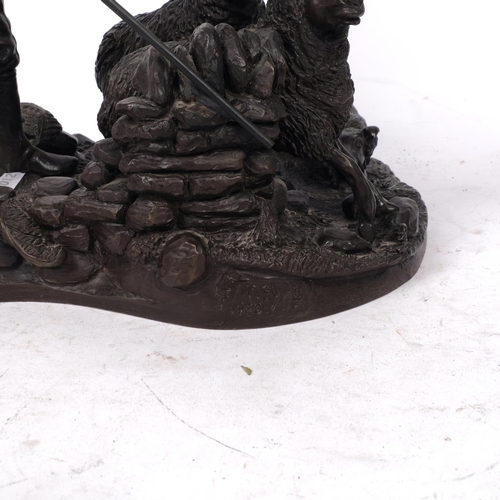 485 - A bronze effect composition sculpture of a shepherd, dog and sheep, H26cm