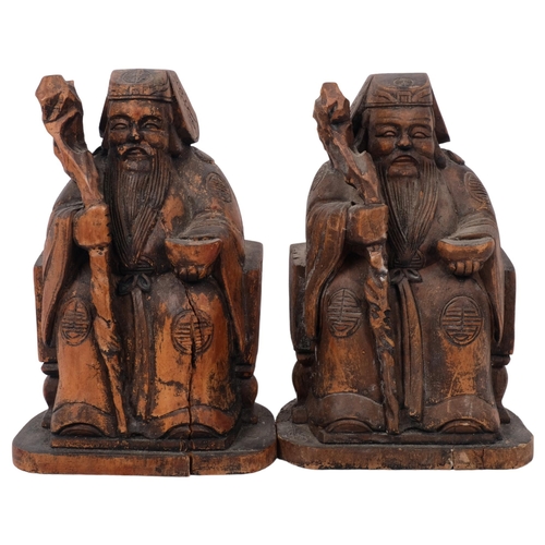 489 - A pair of Chinese carved wood figures with staffs, H20cm