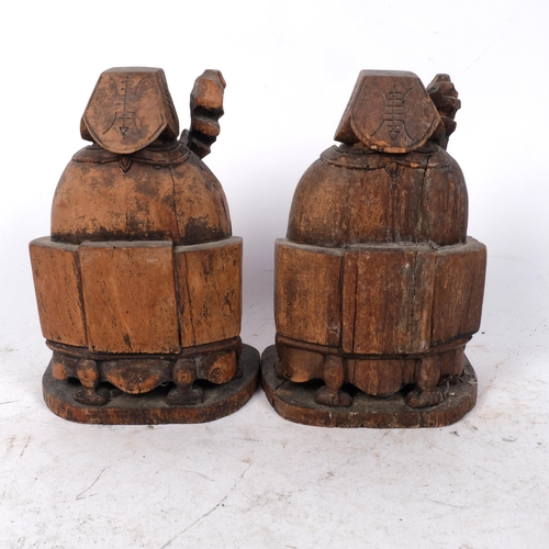 489 - A pair of Chinese carved wood figures with staffs, H20cm