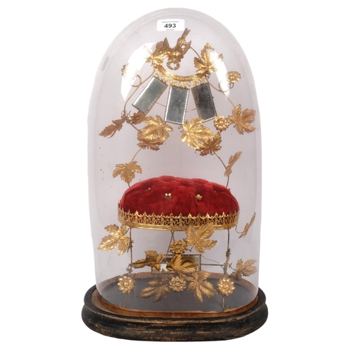 493 - A Victorian glass dome on plinth, H49cm, containing a velvet and gilt-metal stand, mirrors and folia... 