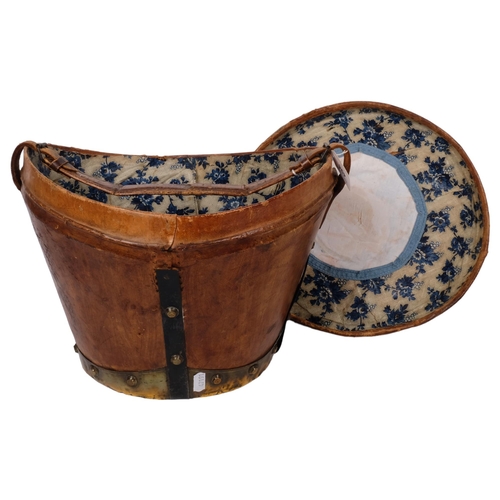 494 - 19th century metal-bound leather hat box and cover, with carrying handle, 34cm across