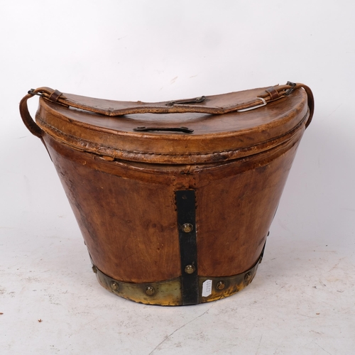 494 - 19th century metal-bound leather hat box and cover, with carrying handle, 34cm across