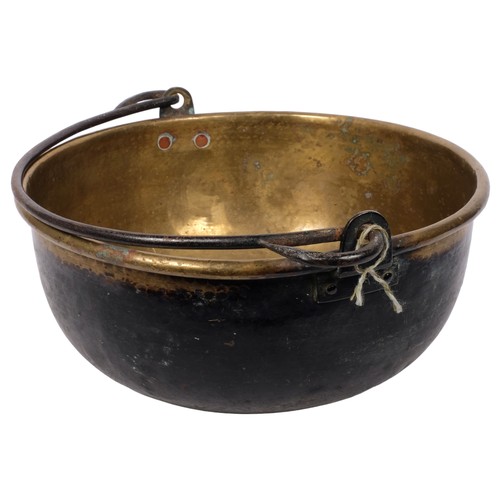 380 - A Victorian brass swing-handled pan