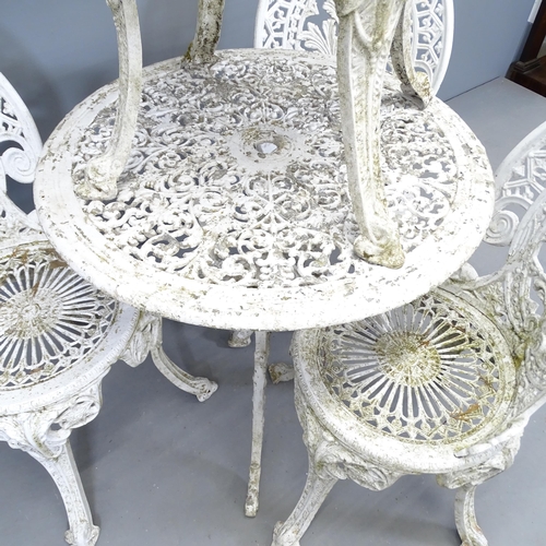 2699 - A painted circular garden table, 68x68cm, and four matching chairs.