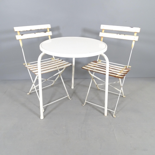 2703 - A painted metal circular-top garden table, 60x70cm and a pair of folding bistro chairs.