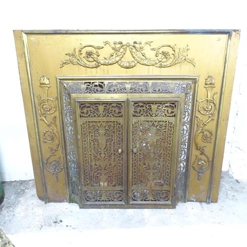 2751 - An antique brass fronted fireplace with applied and pierced decoration. 105x95x30cm.