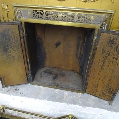 2751 - An antique brass fronted fireplace with applied and pierced decoration. 105x95x30cm.