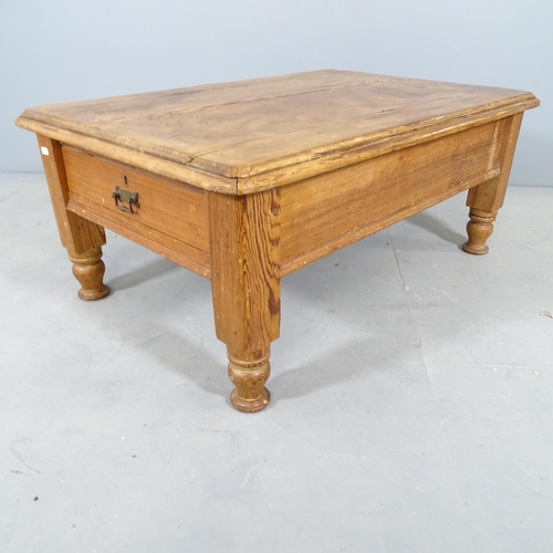 2758 - A waxed pitch pine low coffee table, with end frieze drawer. 94x40x63cm.