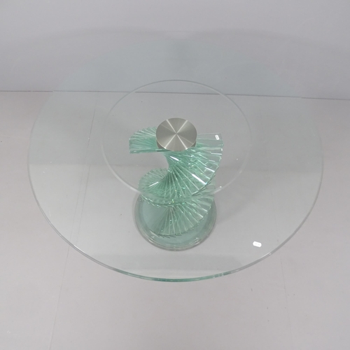 2033 - A contemporary circular glass table with stepped spiral base,  in the manner of Danny Lane. 121x78cm... 