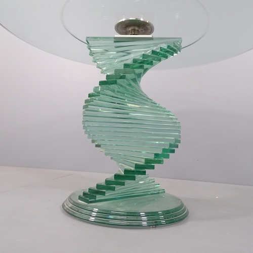 2033 - A contemporary circular glass table with stepped spiral base,  in the manner of Danny Lane. 121x78cm... 