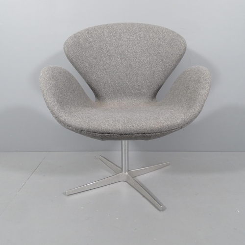 2045 - A mid-century style swivel lounge chair in the manner of the Arne Jacobsen Swan chair.