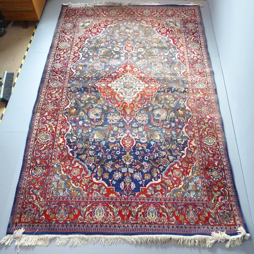 2301 - A red and blue-ground Persian Keshan carpet. 327x203cm.