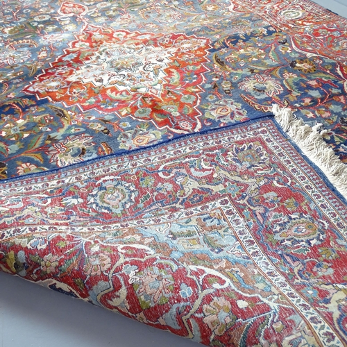 2301 - A red and blue-ground Persian Keshan carpet. 327x203cm.