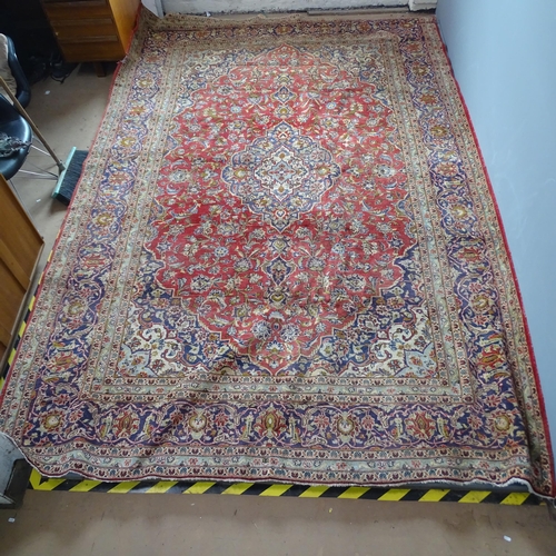 2304 - A red-ground Persian Keshan carpet. 376x247cm.