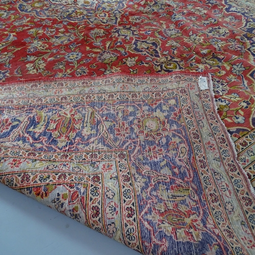 2304 - A red-ground Persian Keshan carpet. 376x247cm.