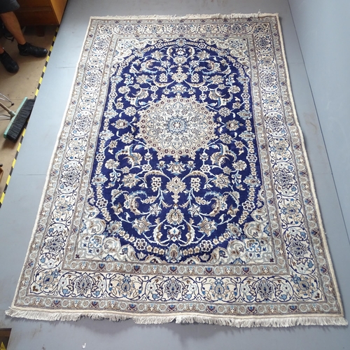 2305 - A cream and blue-ground part silk Isban carpet. 297x200cm.