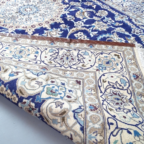 2305 - A cream and blue-ground part silk Isban carpet. 297x200cm.