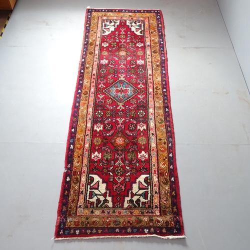 2307 - An Iranian red-ground runner. 265x85cm.