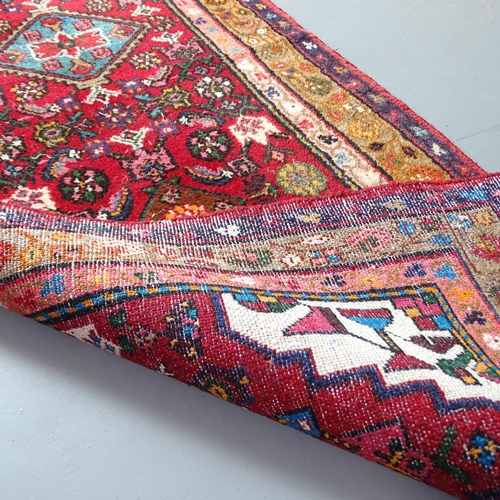 2307 - An Iranian red-ground runner. 265x85cm.