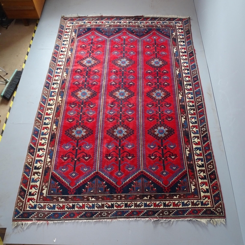 2308 - A red-ground Persian carpet. 293x198cm.