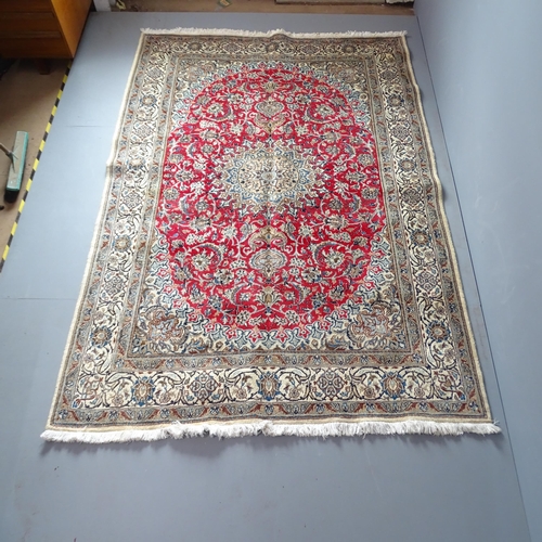 2309 - A red and cream-ground Kerman carpet. 270x193cm.