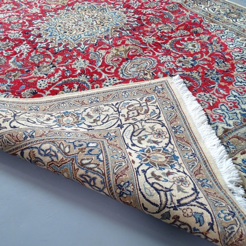 2309 - A red and cream-ground Kerman carpet. 270x193cm.