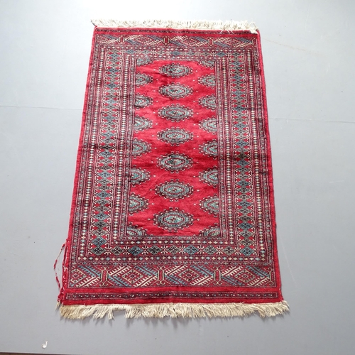 2311 - A red-ground Afghan silk rug. 157x100cm