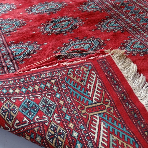 2311 - A red-ground Afghan silk rug. 157x100cm