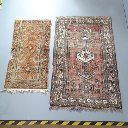 2312 - A red-ground Anatolian rug, 170x107cm, and a small Caucasian mat. (2)