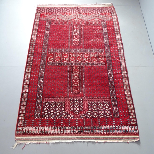 2314 - A red-ground Turkoman Engsi rug. 216x130cm.